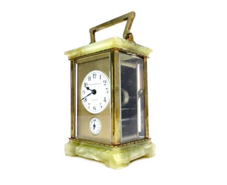 EARLY 20TH CENTURY CARRIAGE CLOCK, with two train movement striking on a bell, the gilt face with white enamel Arabic numeral