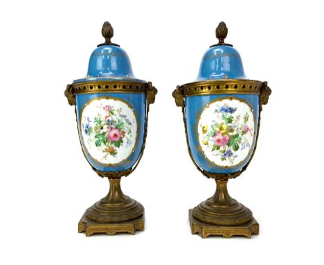 PAIR OF VICTORIAN CERAMIC AND GILTMETAL GARNITURE VASES, the covers with acorn finials, each handpainted with a panel of youn