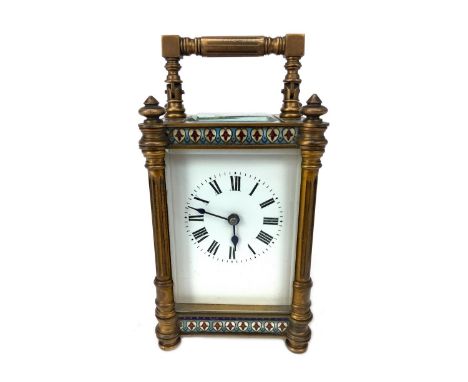 LATE 19TH CENTURY BRASS CARRIAGE CLOCK, with champleve enamel borders in red and blue, the white enamel dial with numerals in
