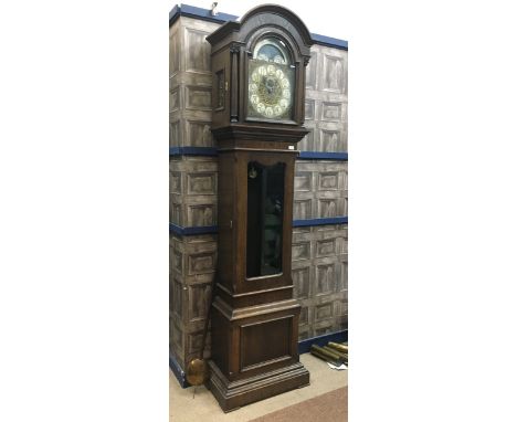 LATE VICTORIAN LONGCASE CLOCK, with three train movement, the dial with pierced brass scrollwork mounts, the silvered chapter