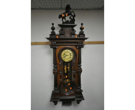 A LATE 19TH CENTURY REGULATOR VIENNA WALL CLOCK, having a resin horse finial, the door with Corinthian columns, enclosing an 