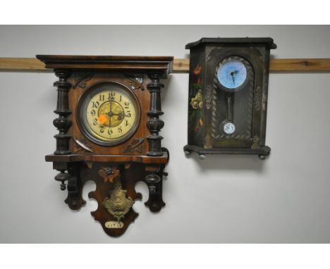 AN EARLY 20TH CENTURY GERMAN WALL CLOCK, with half turned pillar flanking a circular panel glazed panel door enclosing a dial