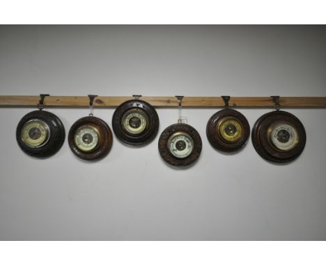 SIX LATE 19TH/EARLY 20TH CENTURY CARVED WOOD CIRCULAR BAROMETERS, all unsigned, largest diameter 22cm (6) (condition:-all in 