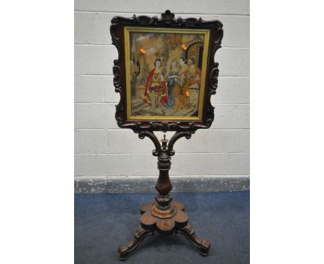 A VICTORIAN ROSEWOOD FIRESCREEN, the shaped foliate frame surrounding needlework scene behind a glass panel, on a shaped supp