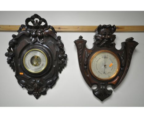 A 20TH CENTURY BLACK FOREST STYLE ANEROID BAROMETER, the frame having a ribbon surmount, foliage, acorns and grapes, surround