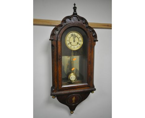 A 19TH CENTURY CONTINENTAL WALNUT WALL CLOCK, having a domed top and door, enclosing a dial with Roman numerals and a mirror 