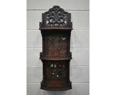 A 20TH CENTURY HARDWOOD JAPANNED WALL SHELF, made up of three shelves, with open foliate fretwork panels and galleries, and c