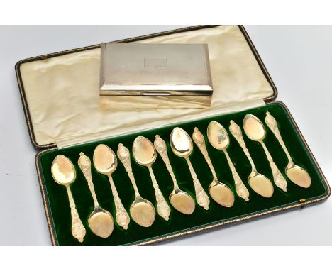 A CASED SET OF TWELVE LATE VICTORIAN SILVER GILT ICE CREAM SPOONS, foliate decoration to the handles, makers James Deakin &am