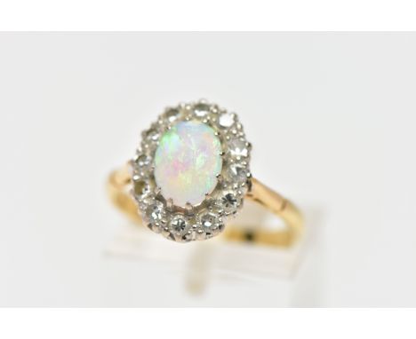 AN OPAL AND DIAMOND CLUSTER RING, set with an oval opal cabochon, measuring approximately 8.2mm x 6.2mm, depth approximately 