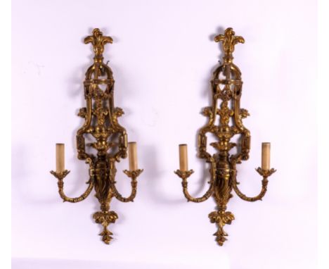 A PAIR OF LOUIS XVI STYLE GILT-METAL TWIN LIGHT WALL APPLIQUES (2)Early 20th Century 
With feather finials and projecting fol