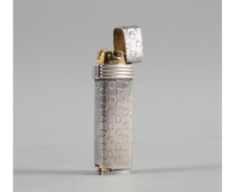 A CHRISTIAN DIOR PARIS GAS LIGHTERThe exterior with C D pattern on an engine turned ground, opening to reveal gilt lighting m