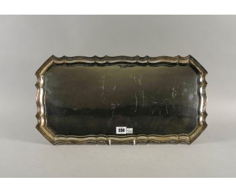 A SILVER SHAPED RECTANGULAR TRAYHaving a Chippendale style border by Walker and Hall, Sheffield 1948, size 52cm x 27.5cm, wei