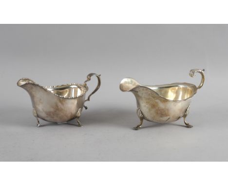 TWO SILVER SAUCEBOATS (2)The first decorated with a beaded rim, scrolling handle and raised on three pad feet, Sheffield 1934