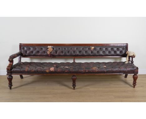 A LARGE MID 19TH CENTURY MAHOGANY FRAMED OPEN ARM BENCHWith button rouge leather upholstery on reeded baluster supports, 287c