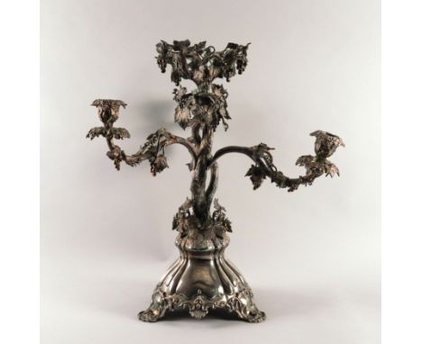 A VICTORIAN SILVER PLATED TABLE CENTREPIECE STANDOf three light candelabra form, in a rustic design, decorated with fruiting 