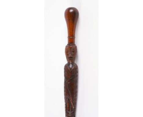 AN INTERESTING MAORI CARVED WALKING CANE OR CEREMONIAL GREETING STICKLate 19th Century
With a baluster grip above a carved fi