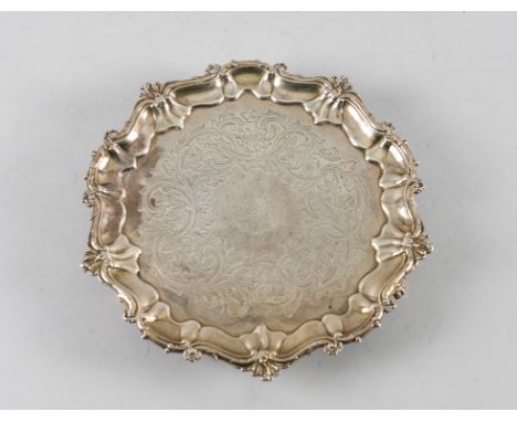 A VICTORIAN SILVER SALVEROf shaped circular form, with a decorated Chippendale style pie-crust rim, engraved with a coat of a
