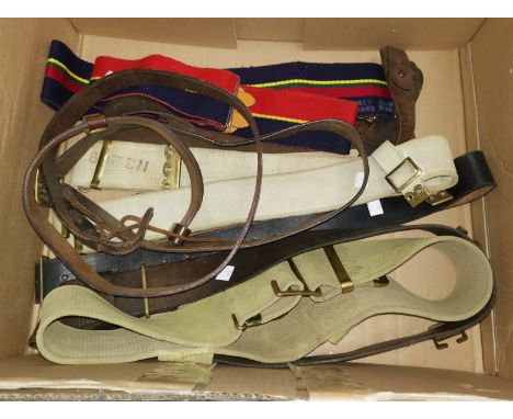 A collection of WWII army belts including canvas and leather examples 