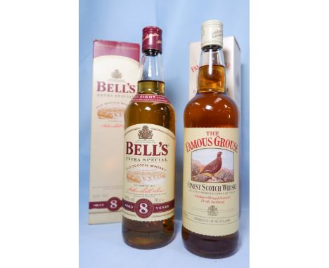 A bottle of Bell's extra special 8 years Scotch whisky 40% alcohol 70cl boxed; a bottle The Famous Grouse Forest Scotch whisk