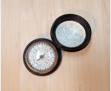 A 19th century compass sundial with printed paper scale and equations of time in turned hardwood case 2 inches 