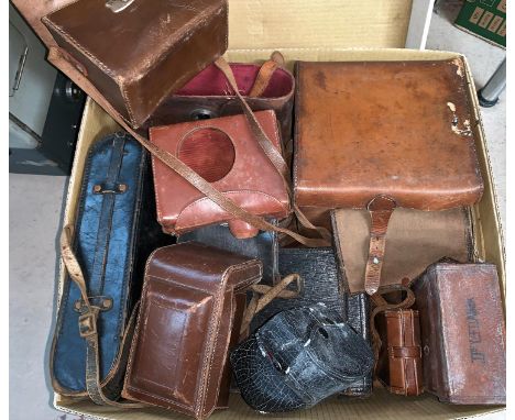 A large collection of vintage camera cases 