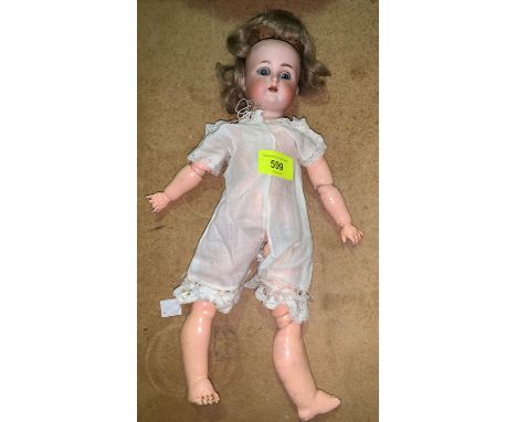 A late 19th century bisque headed doll with the head marked Simon and Halbig K (star)R, jointed compostion body 12 inches lon