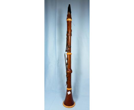 A 19th century pear wood and ivory clarinet by Metzler &amp; Co, London, 23" length excluding mouthpiece 