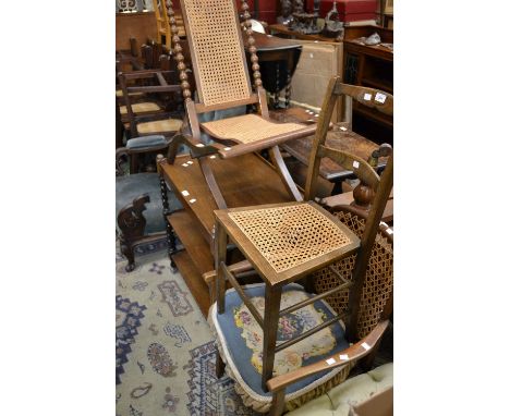 A mahogany steamer chair, cresting pediment, turned finials, bobbin turned uprights, wickerwork back and seat; an oak barley 