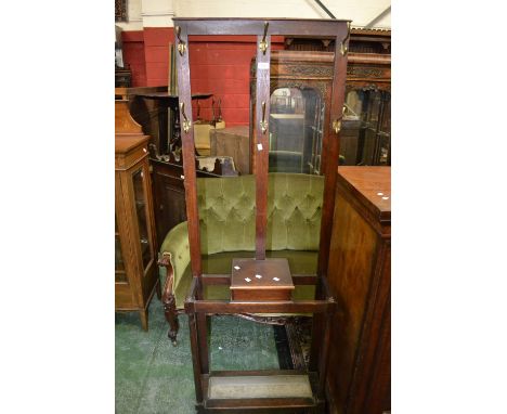 A 1940's oak hall stand, coat hooks to top. glove box and stick stand to base.