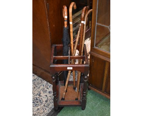 An oak stick stand, four hedgerow walking sticks and an umbrella (6)