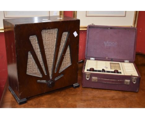 An Art Deco Redifusion radio speaker, mahogany cased, starburst design, 1930's; a Vidor mains portable radio with carrying ca