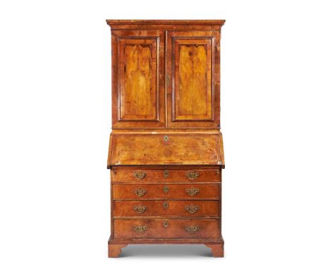 A WALNUT BUREAU BOOKCASE18TH CENTURY AND LATER ADAPTEDWith moulded cornice above a pair of fielded cupboard doors, the slopin