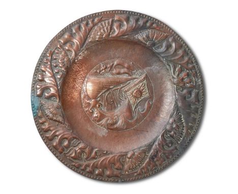 AN ARTS & CRAFTS EMBOSSED AND PLANISHED COPPER CHARGERCIRCA 1895, IN THE MANNER OF THE WORKS BY THE NEWLYN SCHOOLThe outer ed