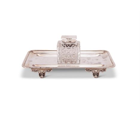 A LATE VICTORIAN SILVER ROUNDED RECTANGULAR INKSTAND BY JOHN ALDWINCKLE & THOMAS SLATER  LONDON 1892 The cut glass cube bottl