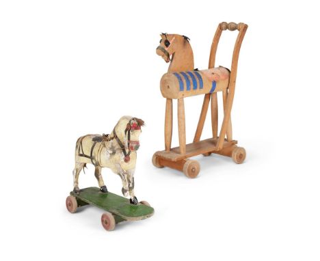 A CHILD'S PULL ALONG TOY HORSEThe prancing animal sponged in black with a gesso ground, hair mane and tail, one wheel missing