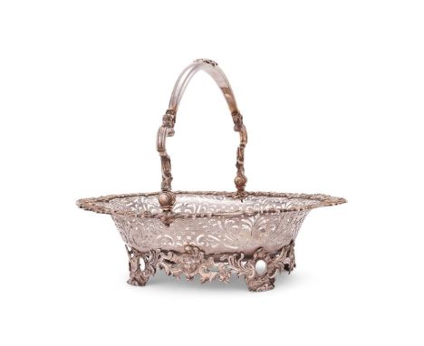 A LATE GEORGE II SILVER SHAPED OVAL FRUIT BASKET BY SAMUEL HERBERT & CO. LONDON 1752The shaped swing handle centred by a vaca