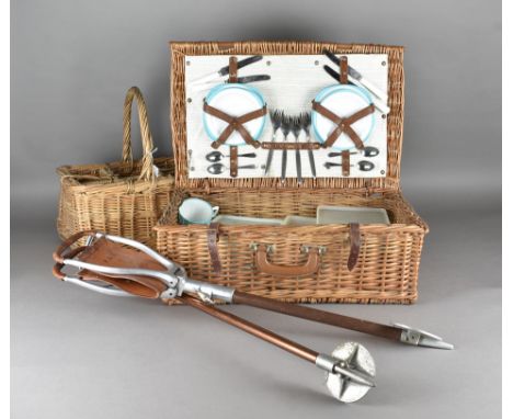 A wicker six-division bottle basket, together with a wicker picnic hamper, two aluminium and chrome shooting sticks (4) 