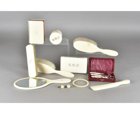 A collection of early 20th Century ivory items,  including various items from a dressing set, comprising three brushes, a mir