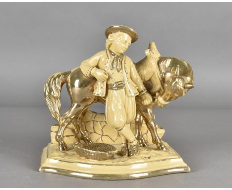 An Eichwald pottery novelty pipe stand, modelled as a young man and his horse heightened in gilt, 19 cm high x 22 cm 