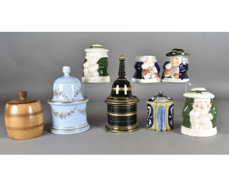 A collection of twelve tobacco jars, including foreign and British examples, by LUC Saint, Doulton Lambeth, Carlton Ware (Dun