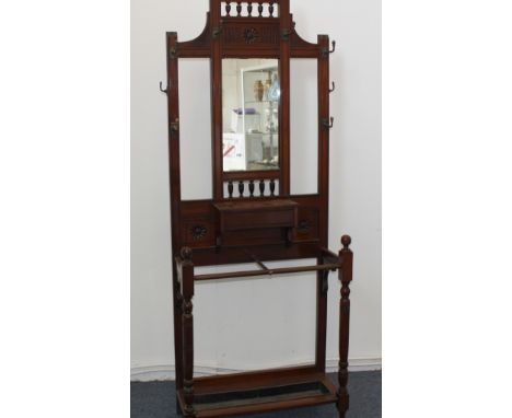 Edwardian Hall Stand, A carved walnut example with hooks and mirror above glove box and stick stand base 76cm wide 31cm deep 