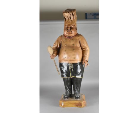 A large fibreglass model of a Continental chef, possibly Belgian, standing holding wooden spoon, 113 cm high 