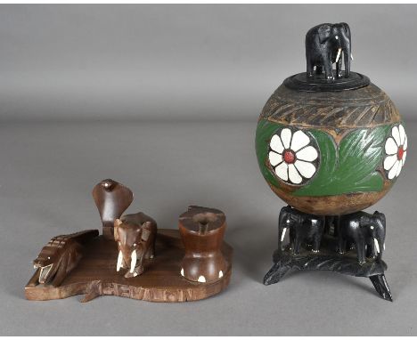 A novelty tobacco jar, one modelled from a coconut shell on carved elephant stand base with elephant finial to lid (af) and a