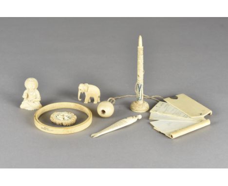 A group of carved ivory and bone objects,  including a carved bone fish with a Stanhope viewer, 11.5  cm long, together with 