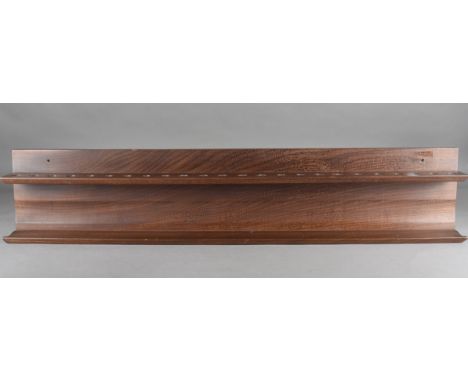 A twenty four hole teak hanging pipe rack, 92 cm long 