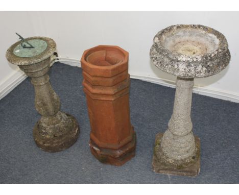 A stone sundial of baluster shape, 76 cm high, together with a stone water bath, 92 cm high, and a terracotta chimney stack o