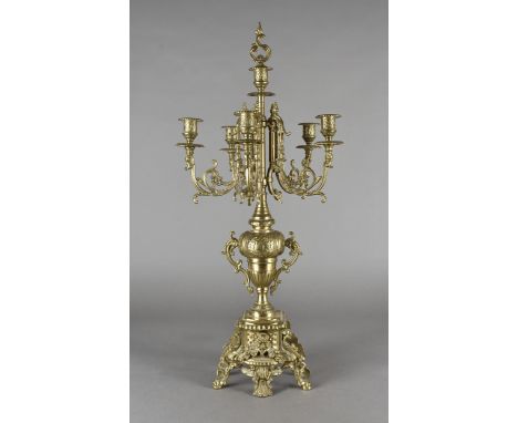 A Victorian six light candelabra, with five scrolling branches, raised on a twin-handled vase support, above an ornate square