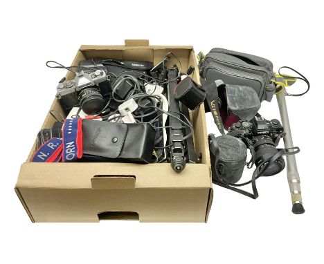 Collection of camera bodies and equipment, including Minolta X-700 camera body with Hoya HMC 55mm Skylight lens, Minolta XG2 