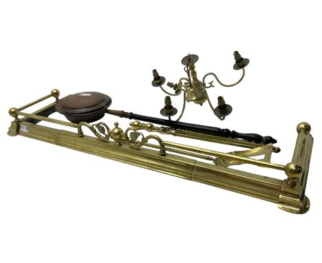 Brass fire fender with scrolled floral decoration (W140cm D43cm); brass fire tools, brass chandelier; and copper warming pan