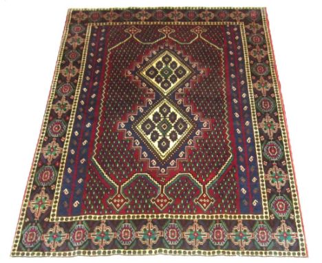 VINTAGE SIRJAN RUG, 201cm x 149cm, double medallion on a rouge  field of boteh guls within a sapphire motifed border.